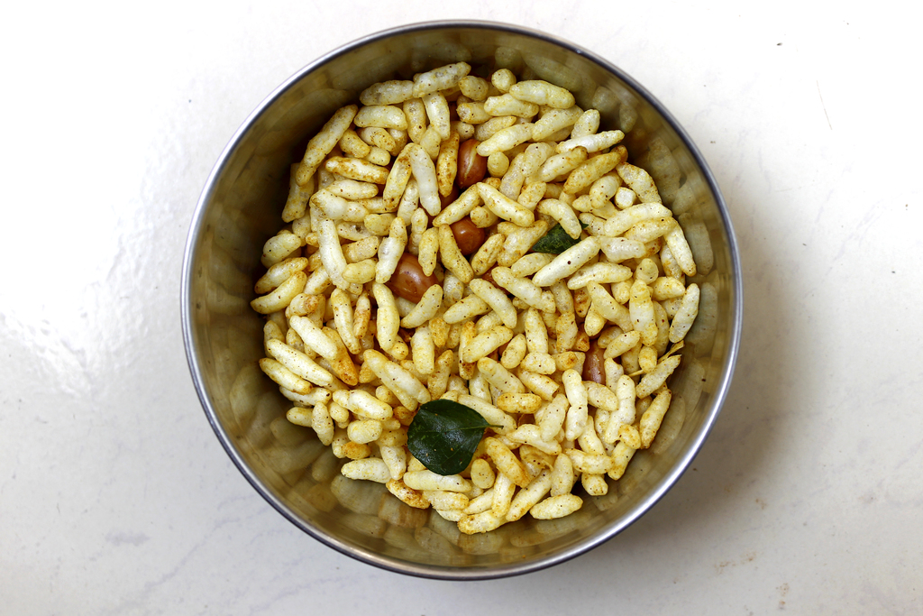 Indian savory snacks made from puffed rice, groundnut, curry leaves with pinch of salt, turmeric & pepper powder