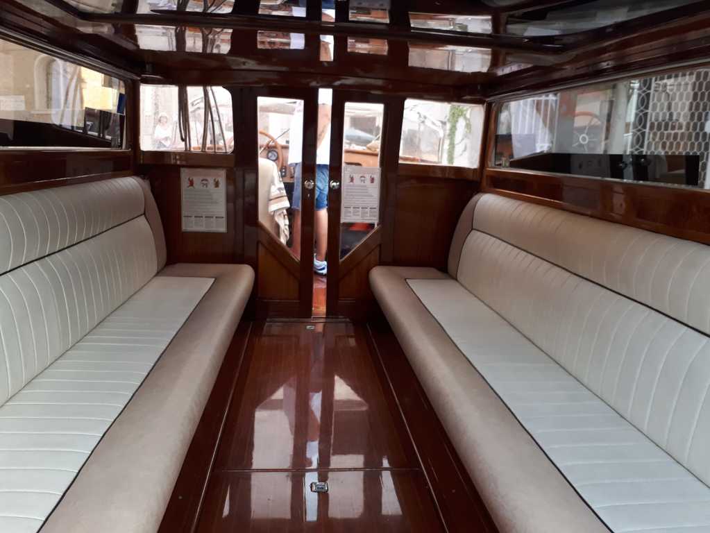 travelling in style in a water taxi in venice | spacious leather-upholstered cabins inside the taxi