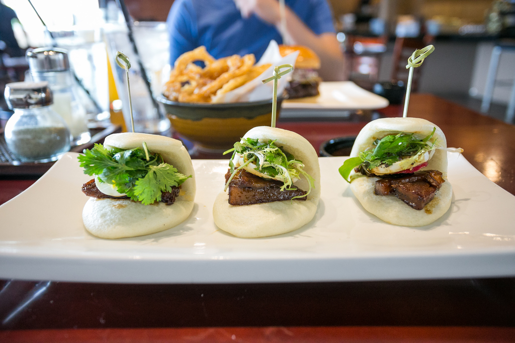 Pork Belly Steamed Buns - Duroc pork belly, cilantro, scallions, radish, boiled egg, Chinese black vinaigrette, hoisin BBQ sauce