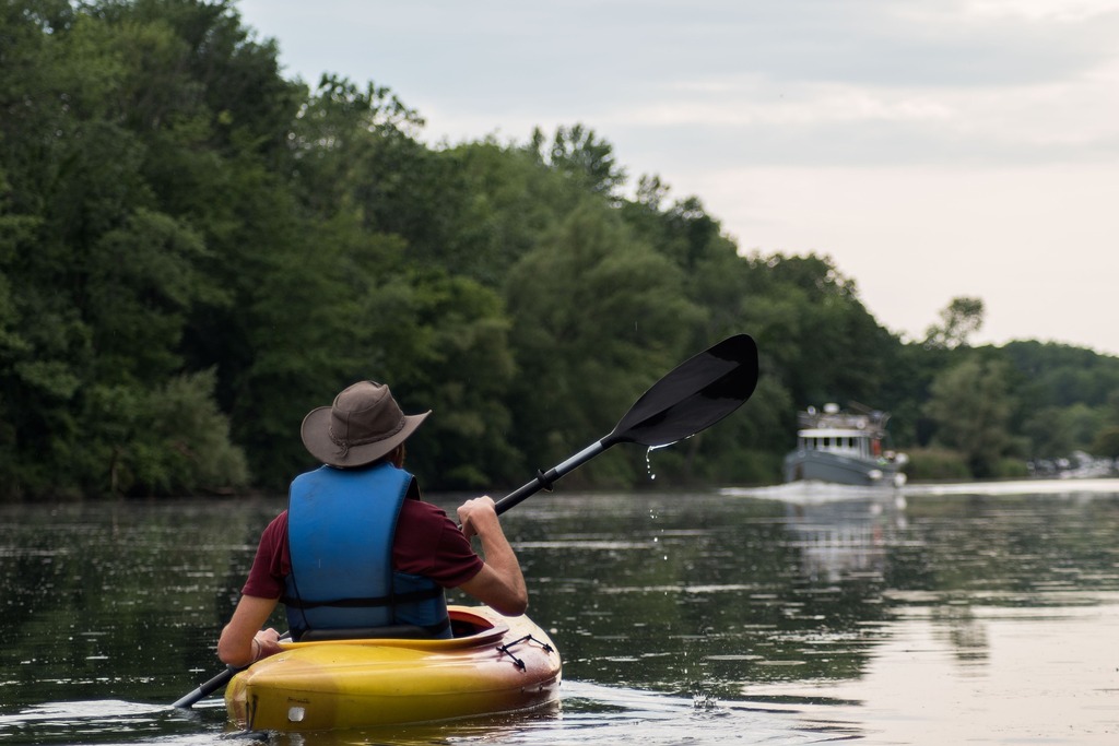 man kayaking on lake
