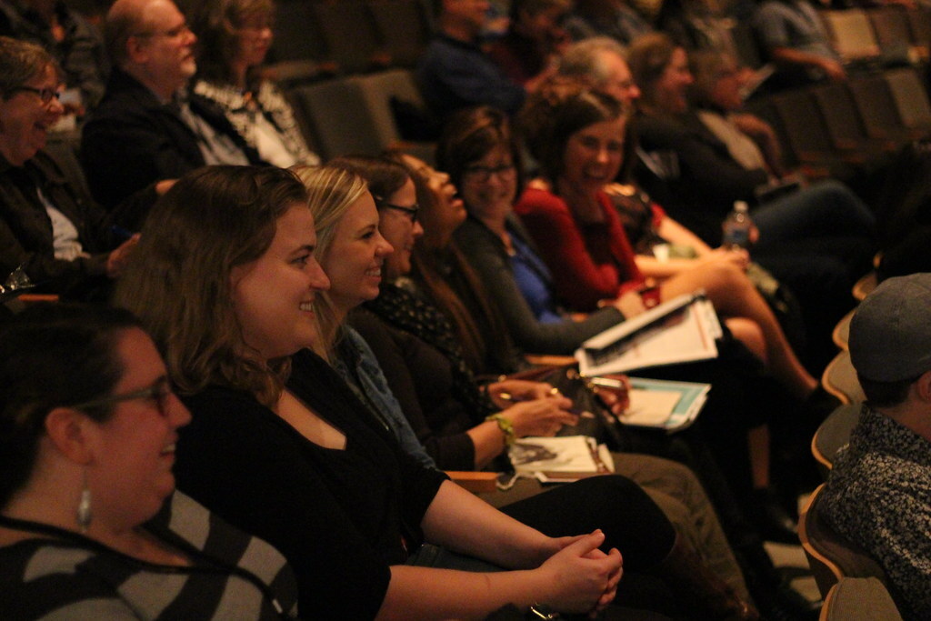 Row of audience laughing at something Chelsea said