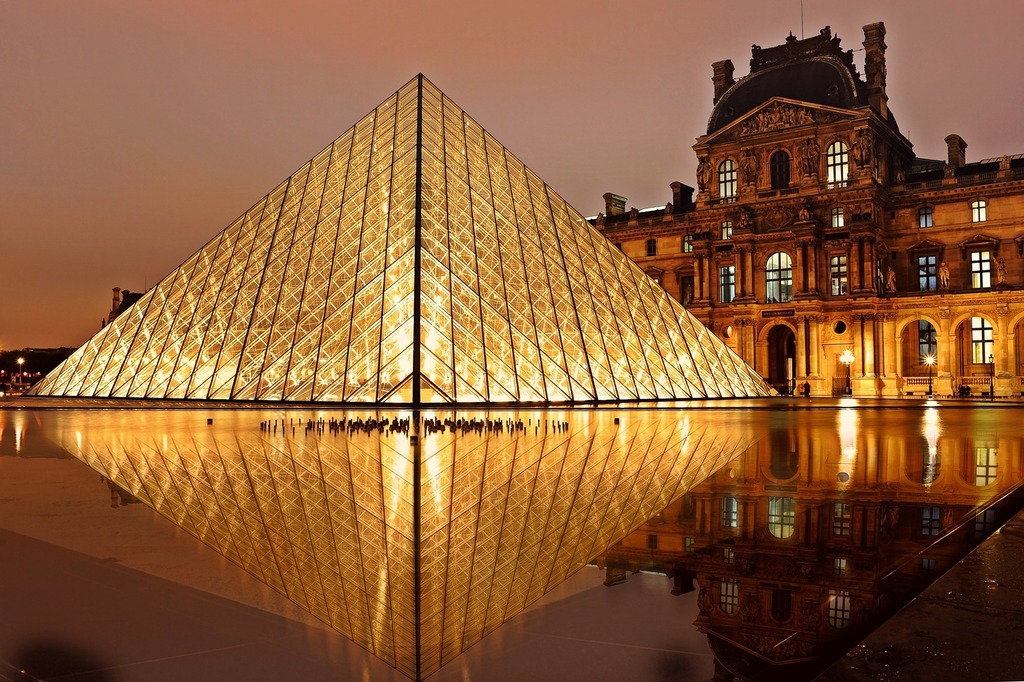 The Louvre and its iconic pyramid lit up at night