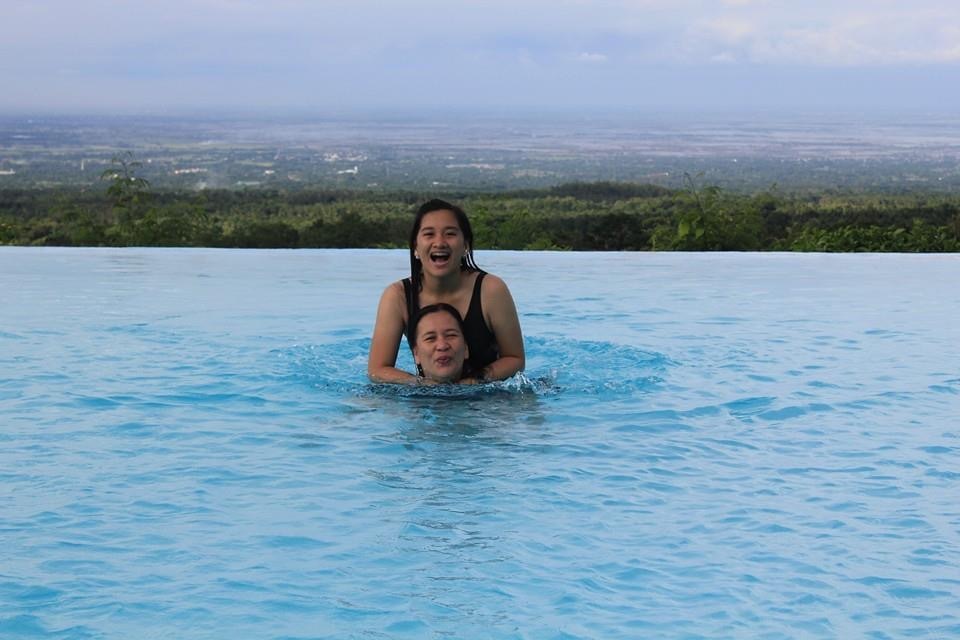 A photo of me and my mother in the infinity pool