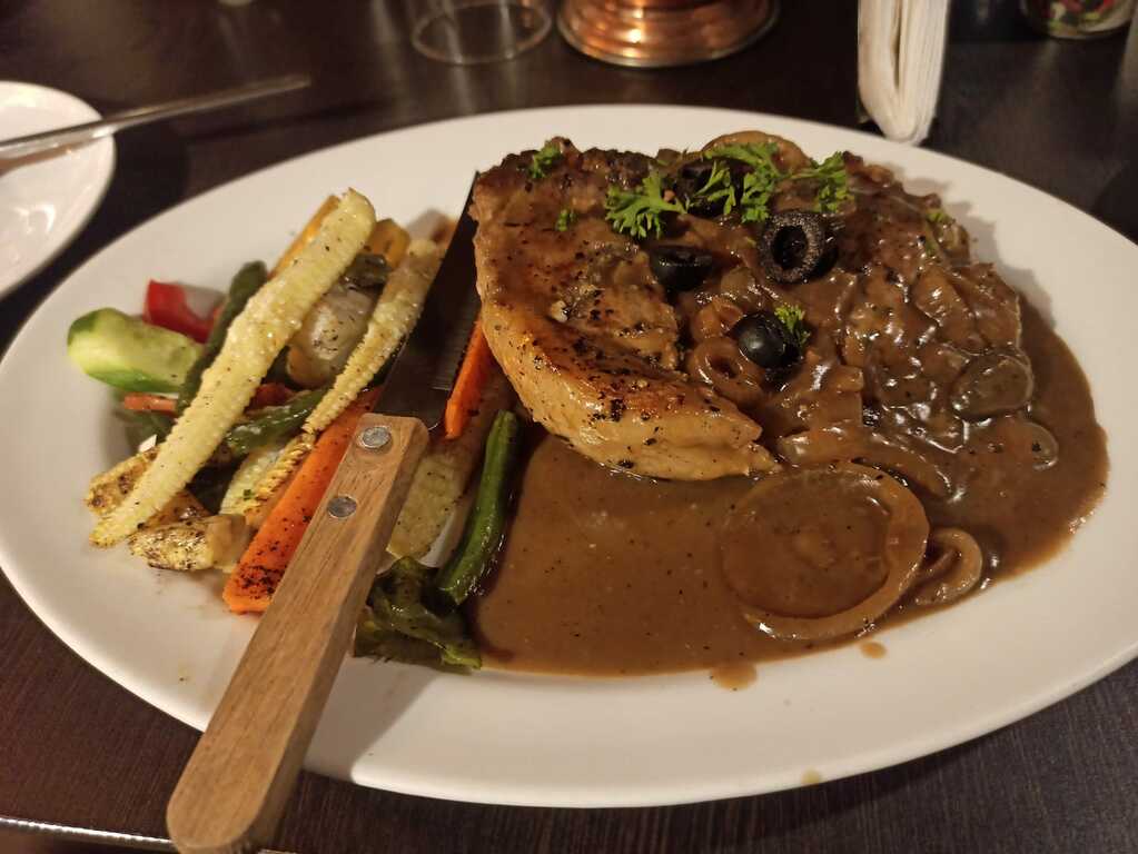 Pork rib with grilled vegetables in mushroom sauce