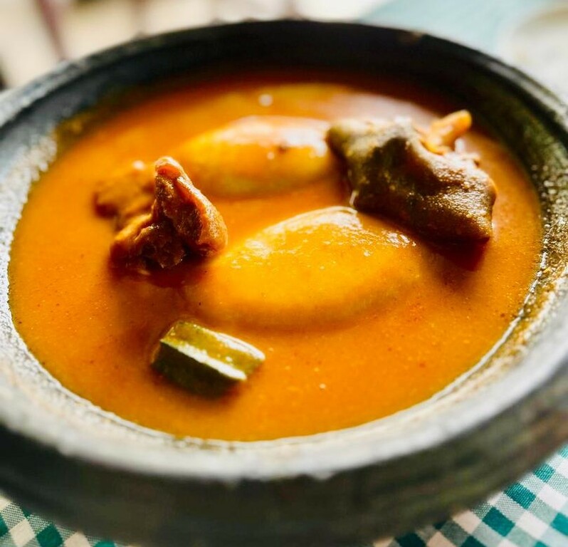 Fufu with light soup and goat meat 