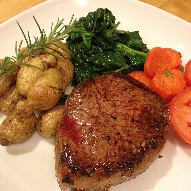 Filet mignon wrapped with bacon with assorted vegetables