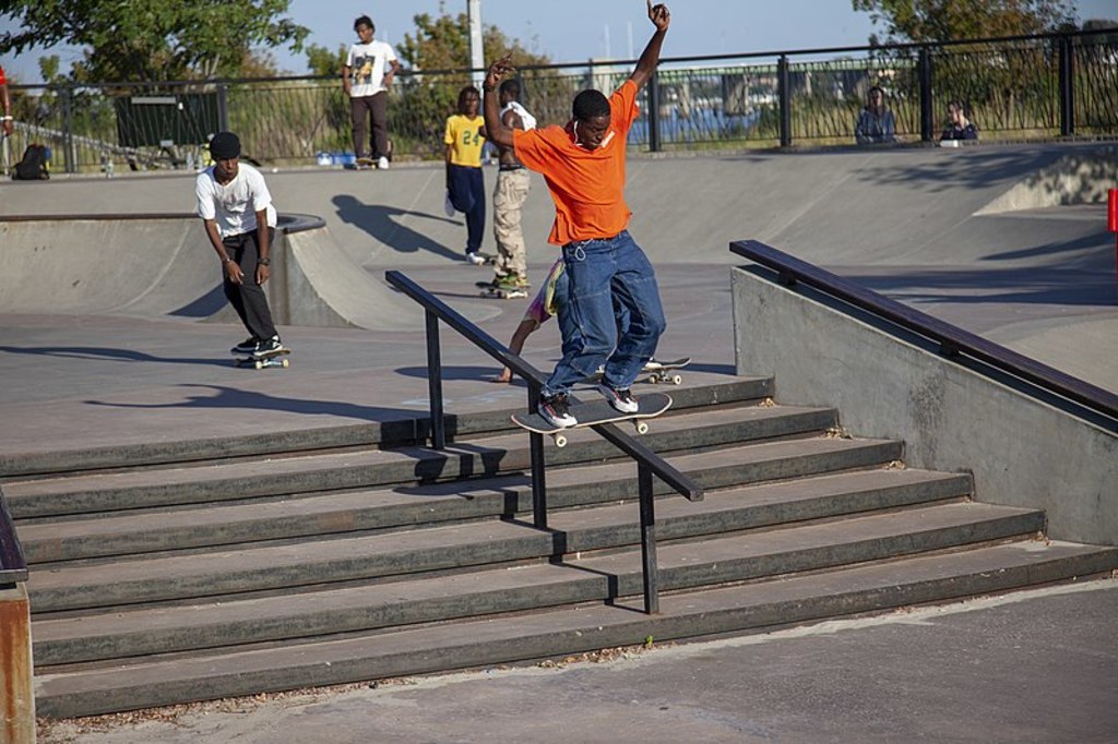 Boardslide in an orange shirt at Far Rockaway Skatepark - 2019