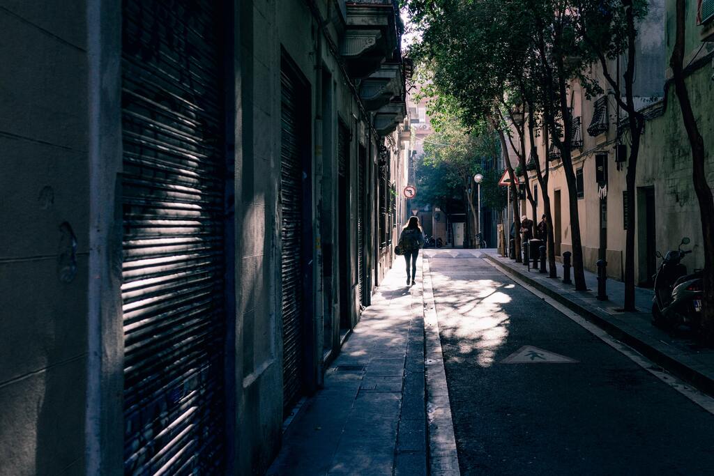 A woman walking in a market alley in Barcelona