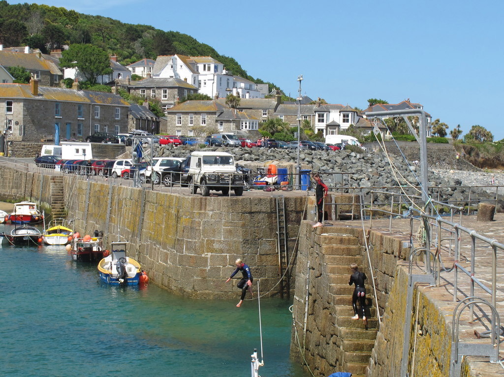 Boys jumping into Mousehole Harbour