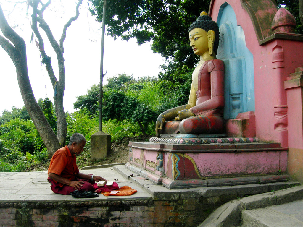A praying Nepalese, Buddhist culture religion rites rituals sights