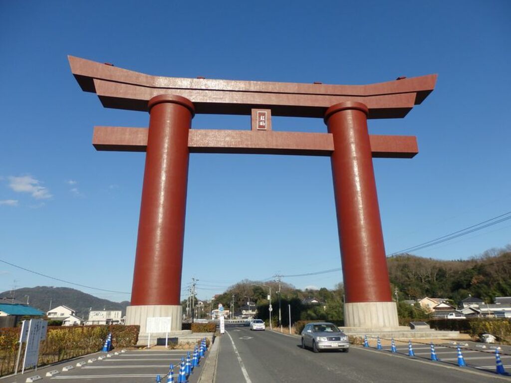 Pass beneath the enormous torii of Saijo Inari
