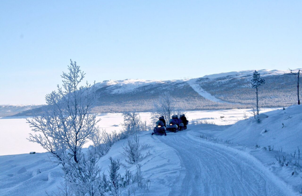 things to do in norway for nature lovers | go snowmobiling in scandinavian landscapes