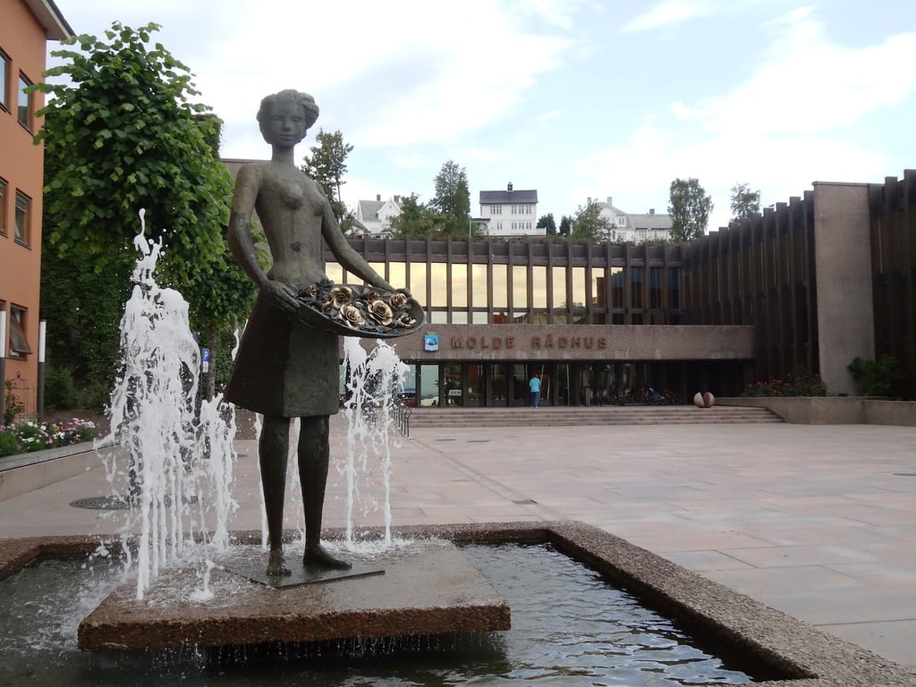 Golden roses and girl statue outside Molde Radhus or Town Hall. Norway.