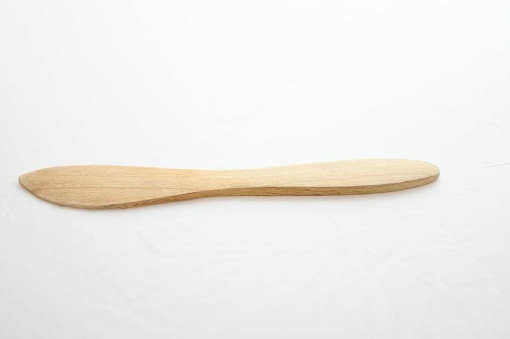 Wooden butter knife isolated on white background
