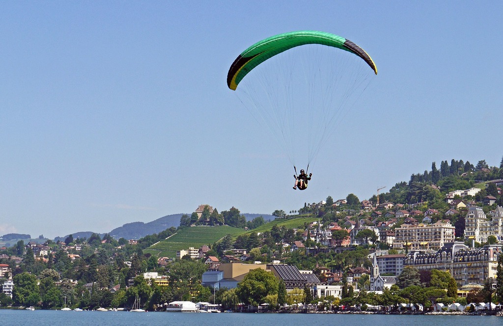 Paragliders flying over Lake Geneva