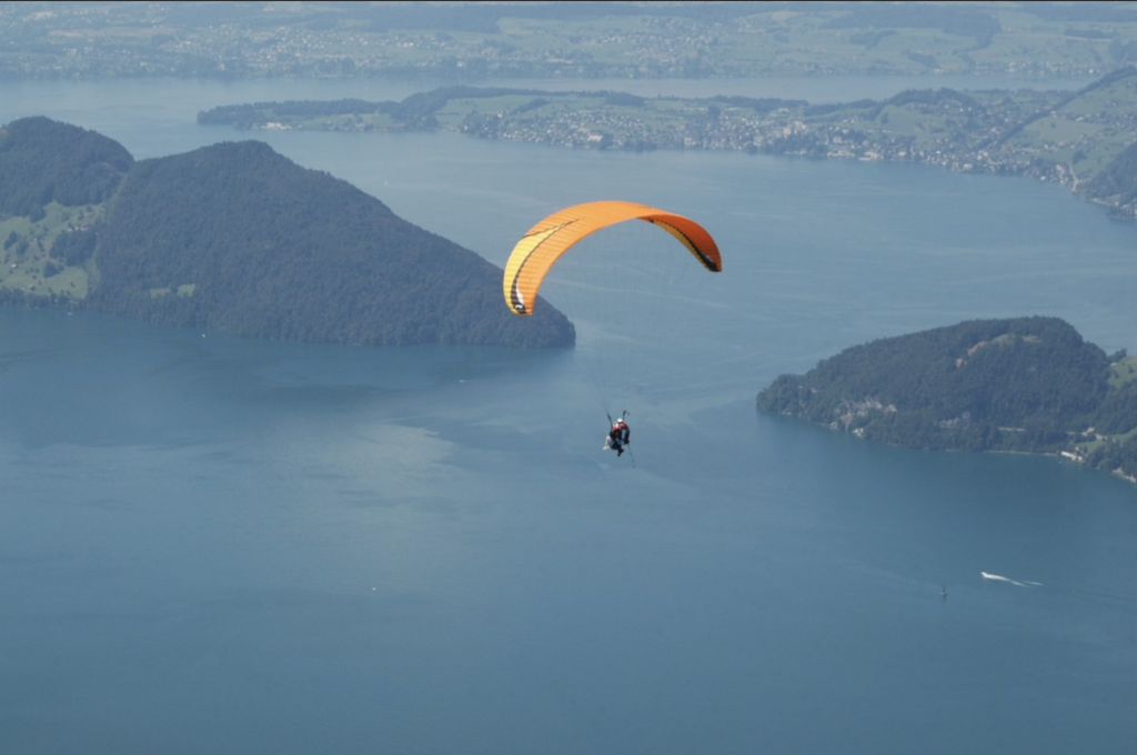 Paraglider flying over Lake Lucerne