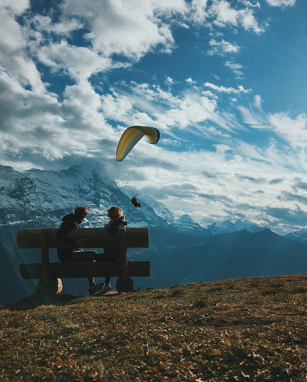 Two boys watching paraglider in Grindelwald, Switzerland