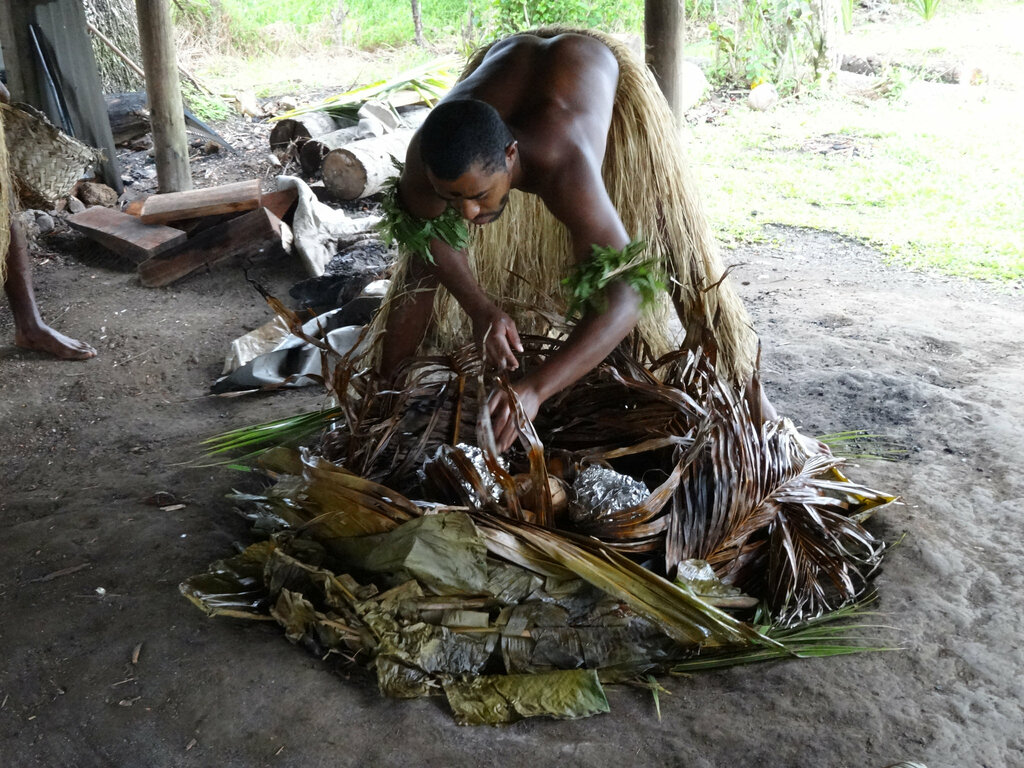 Removing the leaves of the Lovo Koromakawa Village Fiji