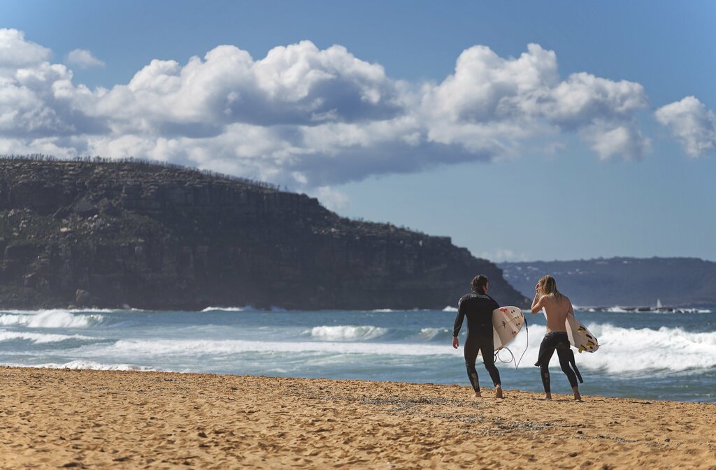 Walk along the beach after surfing at one of the world's best surfing spots, Palm Beach