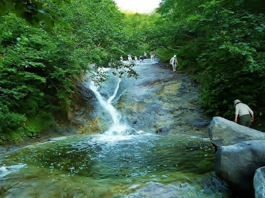 Bathe in the warm waters of Kamuiwakkayu Falls