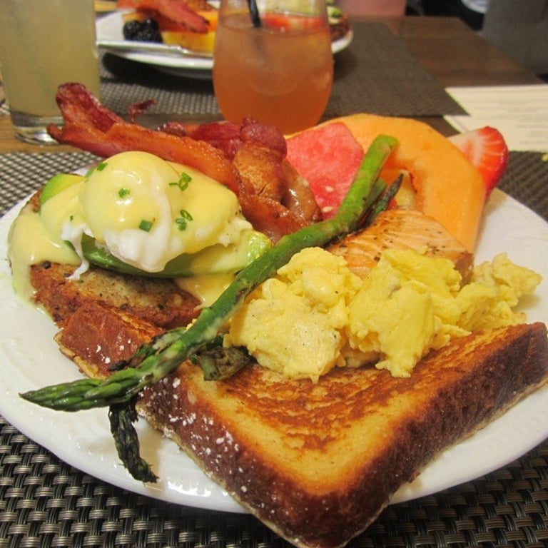 Fully loaded brunch buffet plate from Sadie Kitchen at #BurlesqueBrunchLA. #Vegetarian #Benedict (#quinoa patty, #hollandaise, #avocado and #poached #egg). Also grabbed some #Frenchtoast, #asparagus, #bacon, #strawberries, #watermelon, #cantaloupe, baked