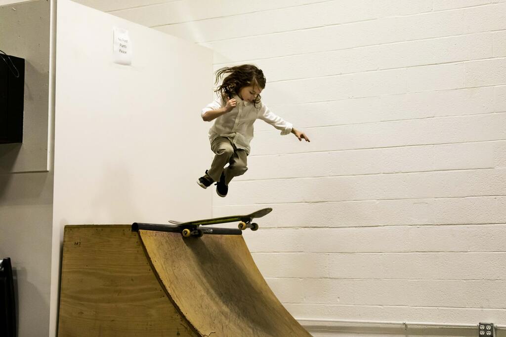 Child playing skateboard at ramp