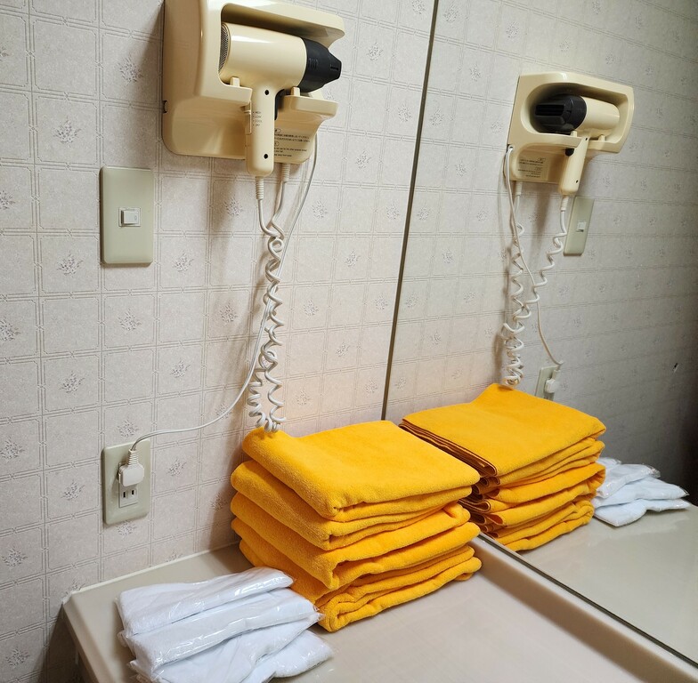 Bathroom with hair dryer and extra towels